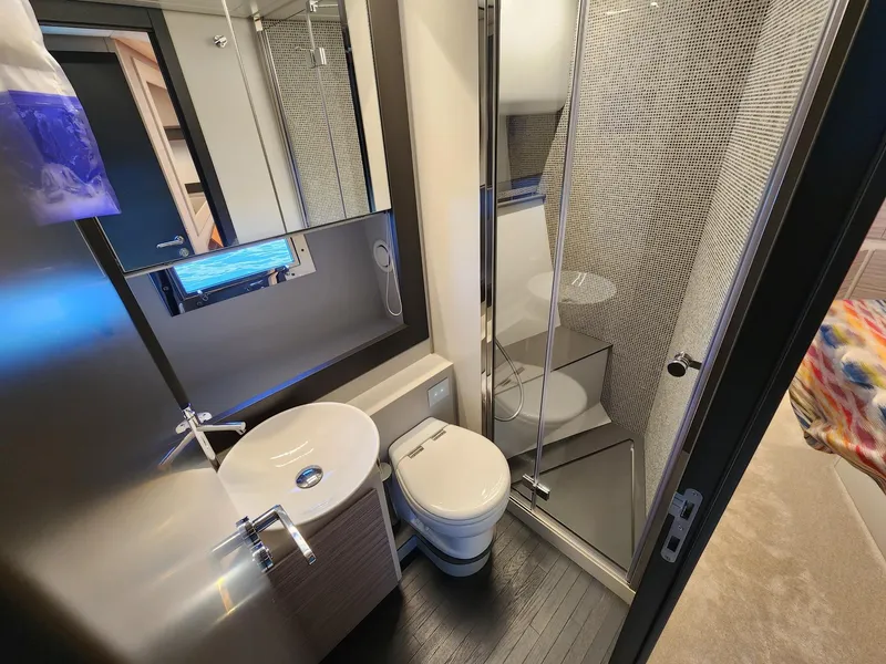 Slide: The Image of Modern bathroom in 2022 Pershing 6X yacht with sleek fixtures and glass shower. - 22