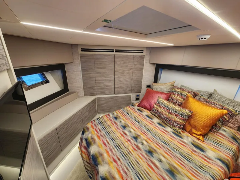 Slide: The Image of Luxurious bedroom interior of 2022 Pershing 6X yacht with colorful bedding and modern design. - 23
