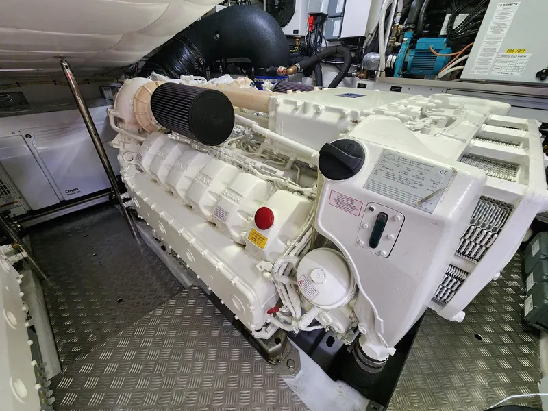 Slide: The Image of Engine room of 2022 Pershing 6X yacht, showcasing advanced machinery and components. - 28