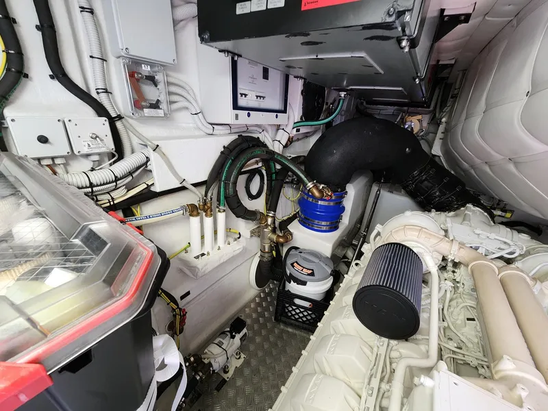 Slide: The Image of Engine room of 2022 Pershing 6X yacht, showcasing mechanical components and wiring. - 32