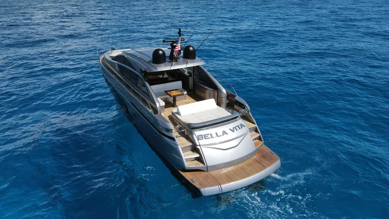 Slide: The Image of 2022 Pershing 6X yacht "Bella Vita" cruising on clear blue ocean waters. - 7