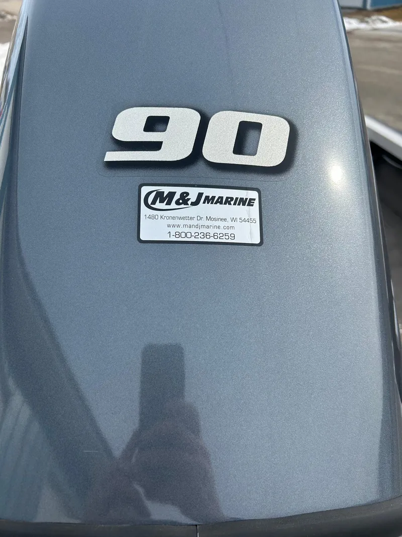 Slide: The Image of 2004 Crestliner 1750 FishHawk SC boat engine with "90" label and M&J Marine sticker. - 13