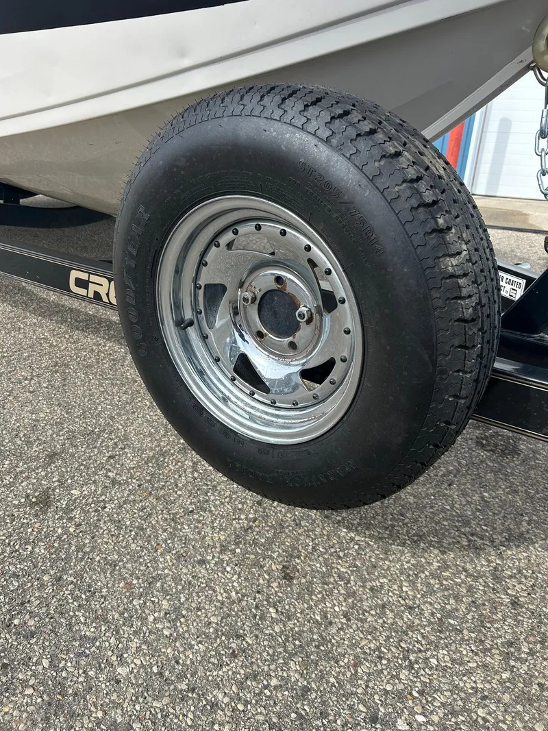 Slide: The Image of Trailer wheel of 2004 Crestliner 1750 FishHawk SC boat on pavement. - 14