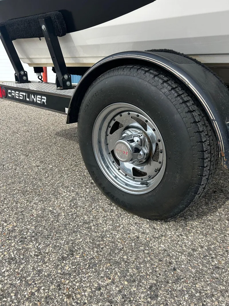 Slide: The Image of Trailer wheel of 2004 Crestliner 1750 FishHawk SC on asphalt surface. - 15