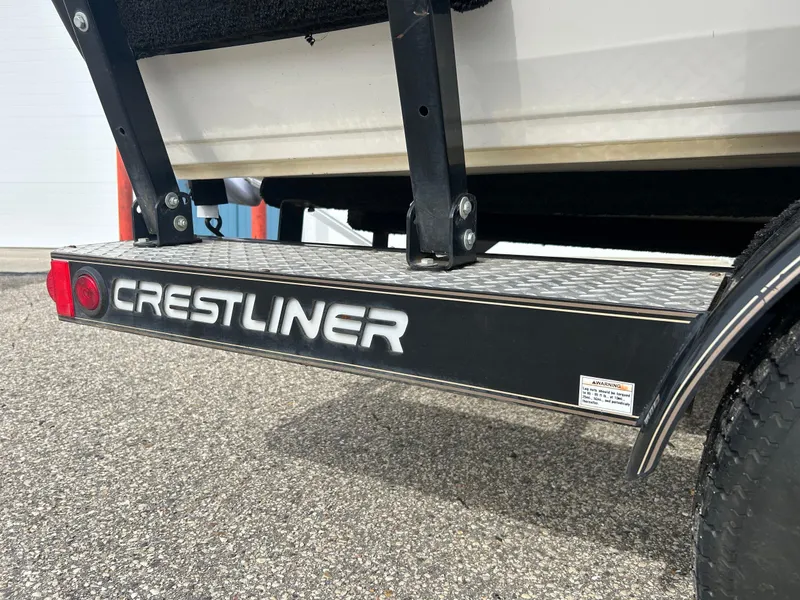 Slide: The Image of Crestliner 1750 FishHawk SC 2004 boat trailer detail on pavement. - 16