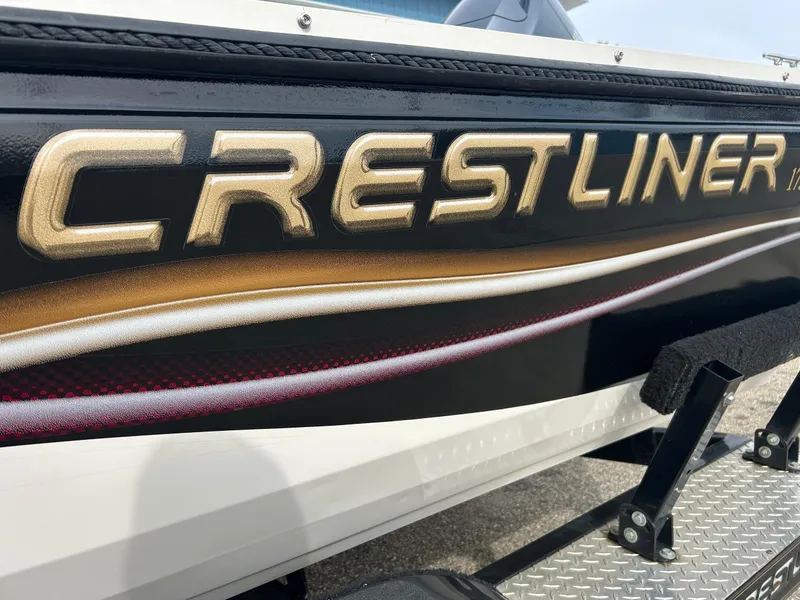 Slide: The Image of 2004 Crestliner 1750 FishHawk SC boat, close-up of logo and side design. - 18