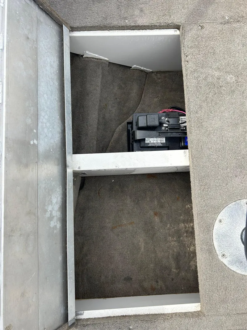Slide: The Image of 2004 Crestliner 1750 FishHawk SC boat battery compartment with carpeted interior. - 30