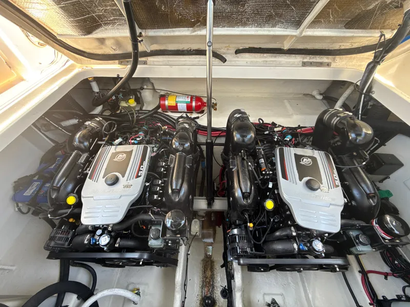 Slide: The Image of Engine compartment of 2010 Sea Ray 310 Sundancer with dual engines and fire extinguisher. - 21