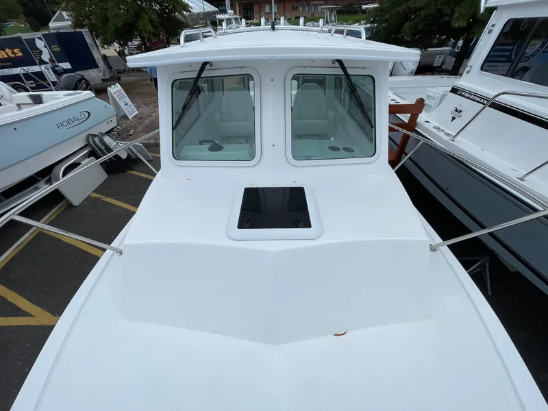 Slide: The Image of 2025 Steiger Craft 255 DV MIAMI boat, white exterior, docked in a marina. - 5