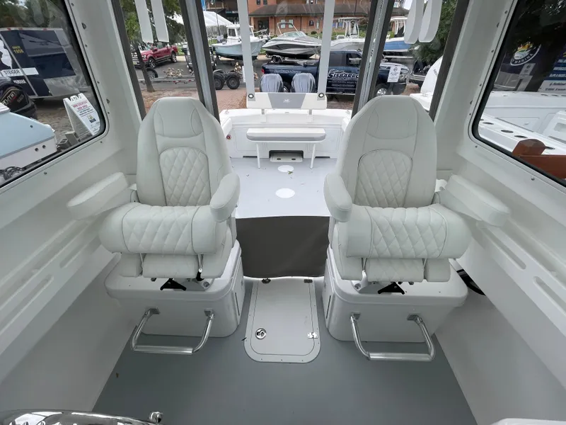 Slide: The Image of 2025 Steiger Craft 255 DV MIAMI boat interior with two white captain's chairs. - 6