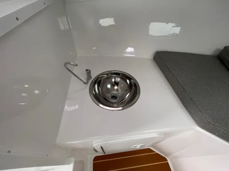 Slide: The Image of 2025 Steiger Craft 255 DV MIAMI interior with sink and cushioned seating. - 8