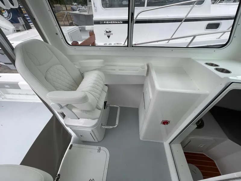 Slide: The Image of 2025 Steiger Craft 255 DV MIAMI boat interior with captain's chair and console. - 9