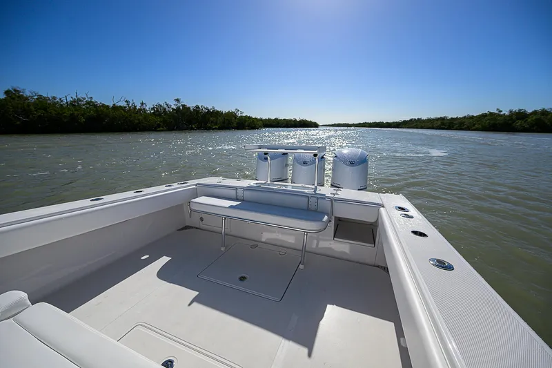 Slide: The Image of 2017 Bahama 41 boat on calm water, clear sky, spacious deck view. - 11