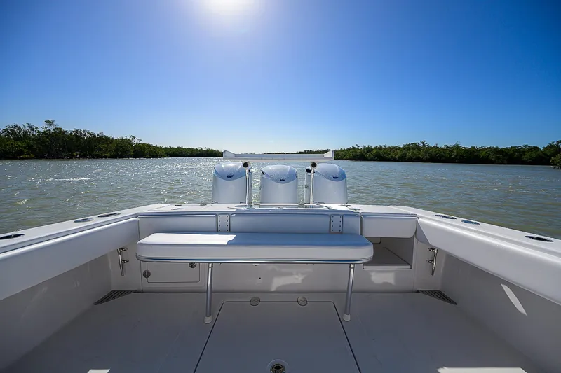 Slide: The Image of 2017 Bahama 41 boat with triple engines on a sunny day. - 13