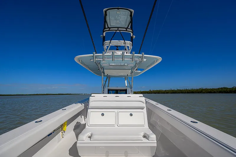 Slide: The Image of 2017 Bahama 41 boat on calm water under clear blue sky. - 17