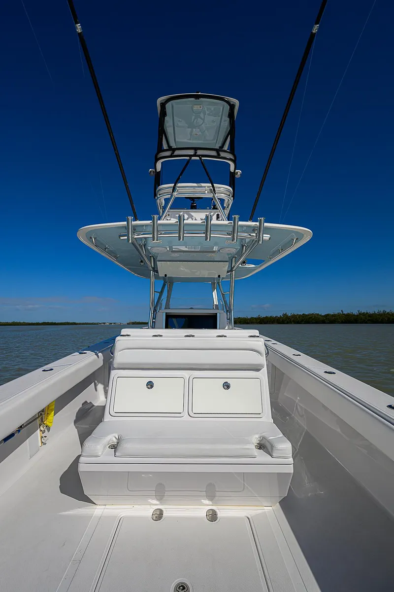 Slide: The Image of 2017 Bahama 41 boat with dual consoles and tower against clear blue sky. - 18