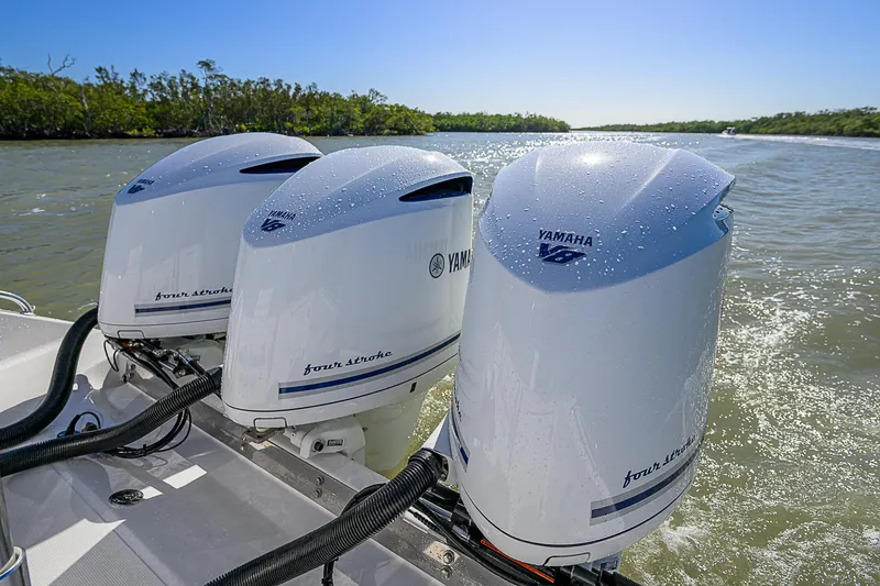 Slide: The Image of Triple Yamaha outboard engines on a 2017 Bahama 41 boat cruising in sunny waters. - 22