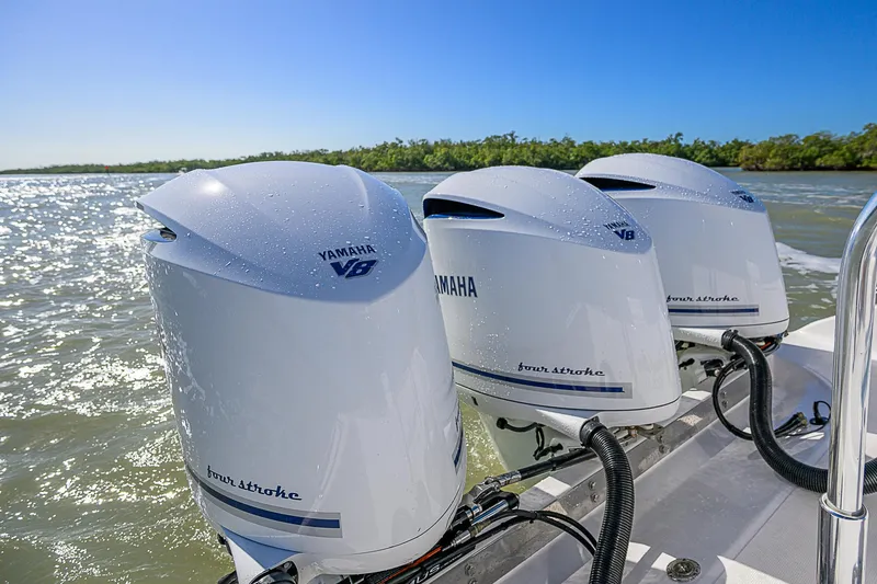 Slide: The Image of Triple Yamaha outboard engines on a 2017 Bahama 41 boat, cruising on a sunny day. - 23