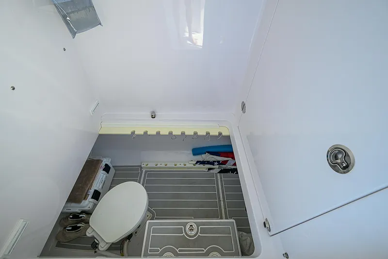 Slide: The Image of Interior of 2017 Bahama 41 boat bathroom with toilet and storage space. - 24