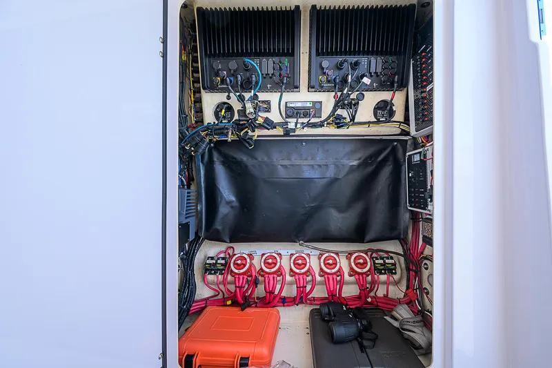 Slide: The Image of Electrical panel inside a 2017 Bahama 41 boat, featuring wiring and equipment. - 26