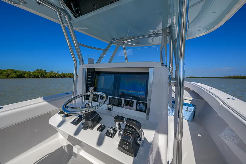Slide: The Image of 2017 Bahama 41 boat helm with advanced navigation system on calm waters. - 29