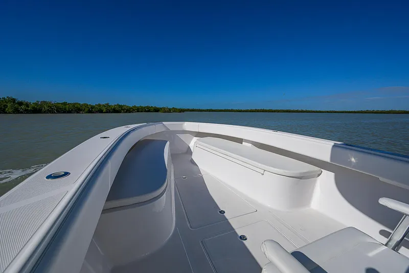 Slide: The Image of 2017 Bahama 41 boat deck with seating, cruising on calm waters under clear blue sky. - 3