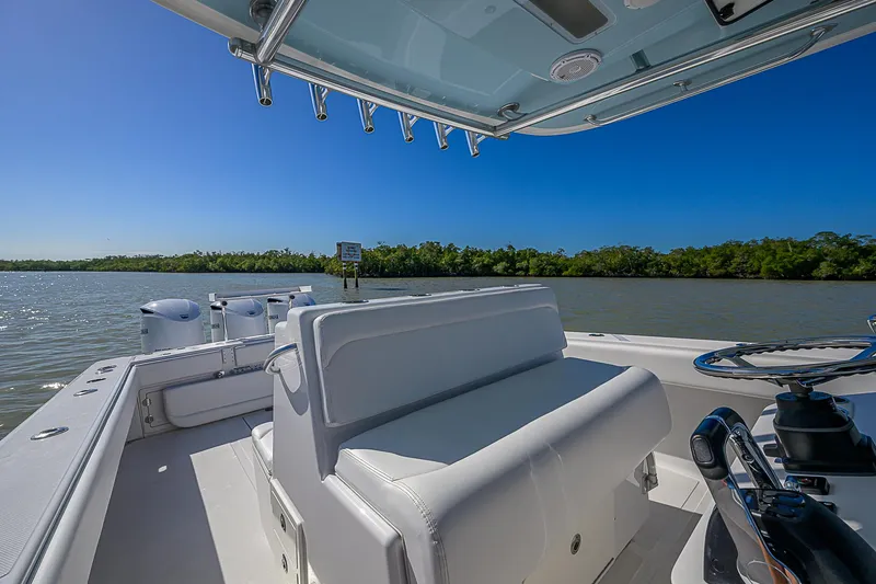 Slide: The Image of 2017 Bahama 41 boat on calm water, featuring sleek seating and clear blue skies. - 31