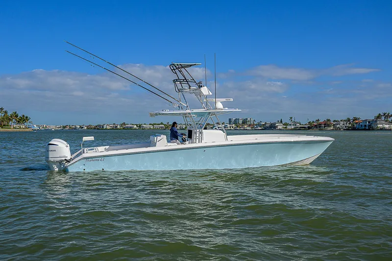 Slide: The Image of 2017 Bahama 41 boat cruising on a sunny day in calm waters. - 33