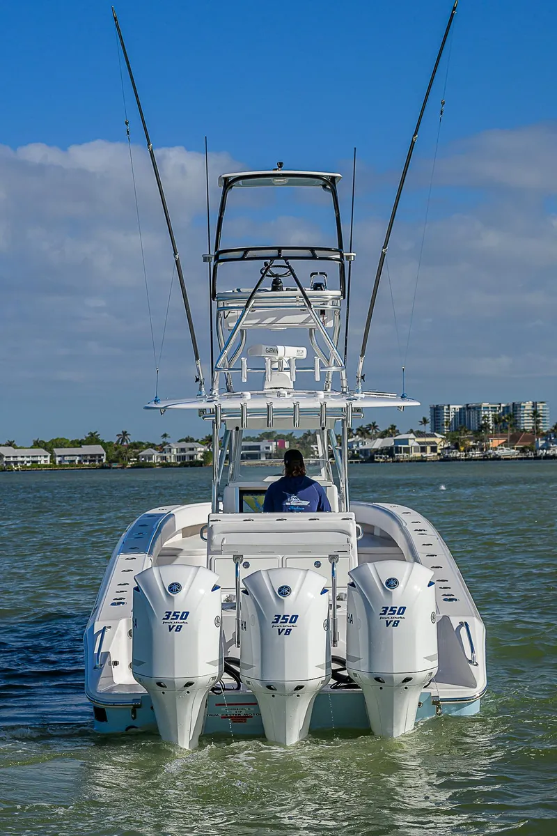Slide: The Image of 2017 Bahama 41 boat with triple 350 engines cruising on water. - 39