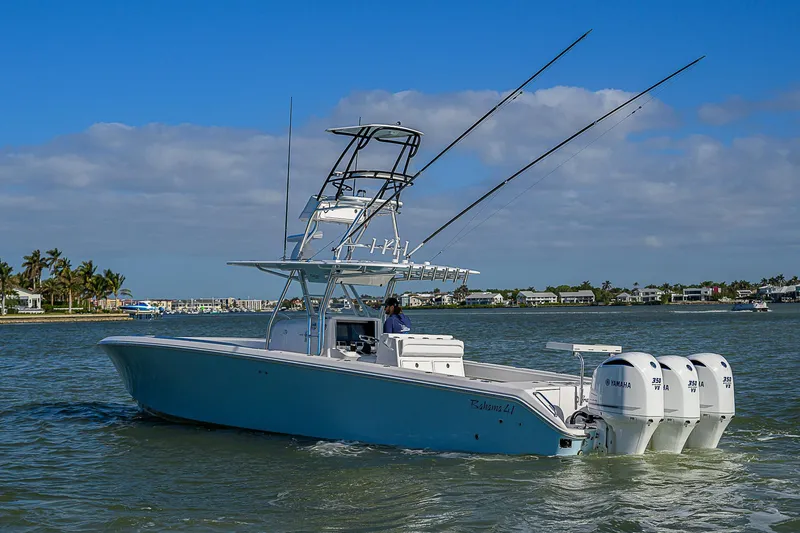 Slide: The Image of 2017 Bahama 41 boat with triple Yamaha engines cruising on a sunny day. - 40