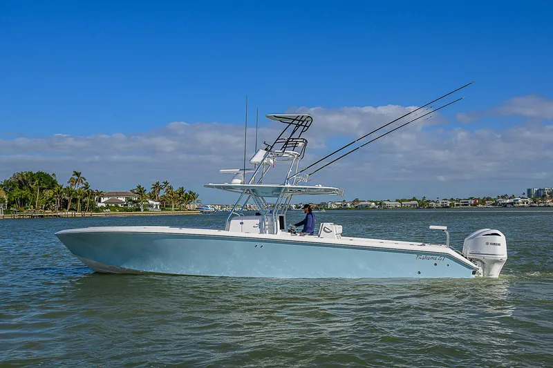 Slide: The Image of 2017 Bahama 41 boat cruising on a sunny day with clear blue skies. - 43
