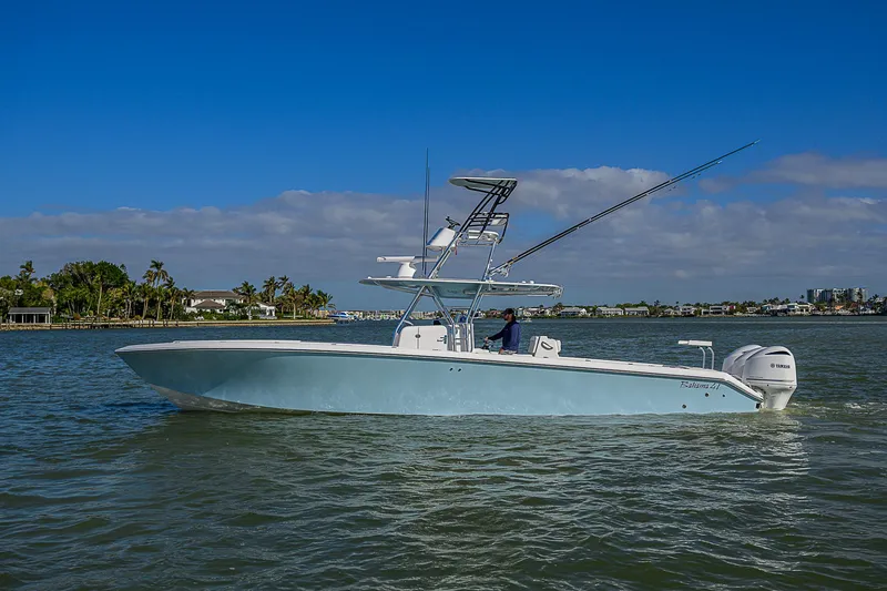 Slide: The Image of 2017 Bahama 41 boat on calm water under a clear blue sky. - 44