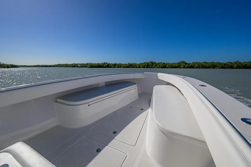 Slide: The Image of 2017 Bahama 41 boat on calm water, clear sky, spacious deck view. - 5