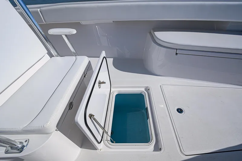 Slide: The Image of 2017 Bahama 41 boat interior with open storage compartment and seating area. - 7