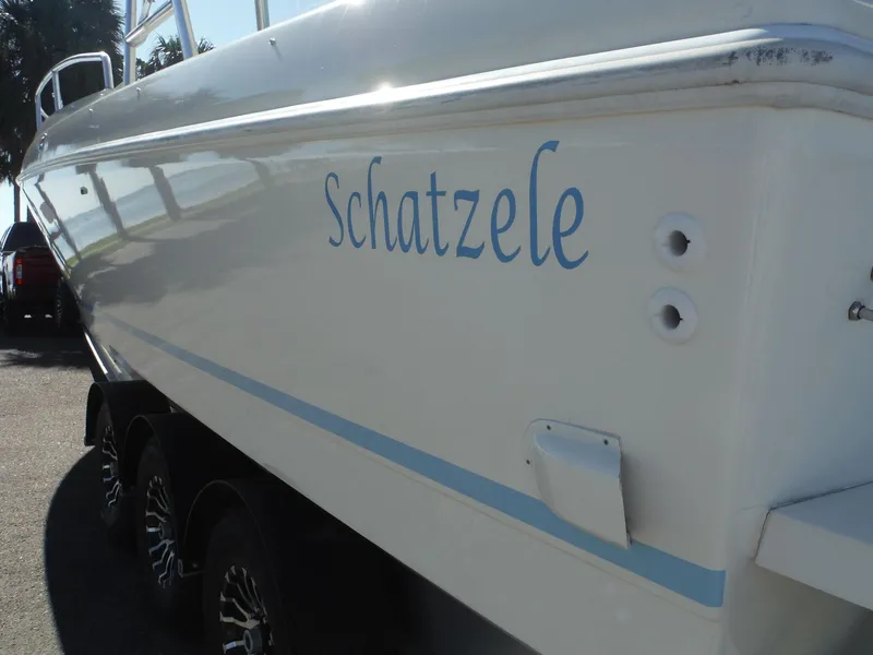 Slide: The Image of Side view of a 1996 Intrepid 339 Walk Around boat on a trailer. - 17