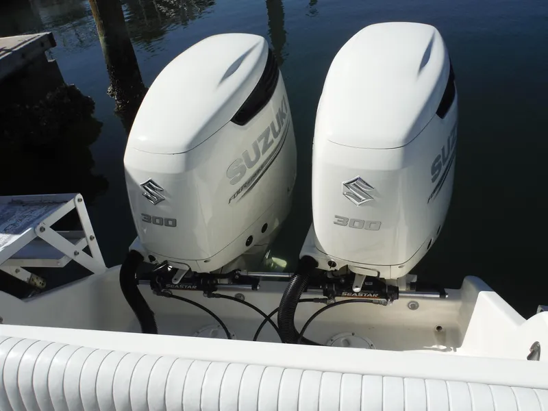 Slide: The Image of 1996 Intrepid 339 Walk Around with dual outboard motors at a marina. - 21