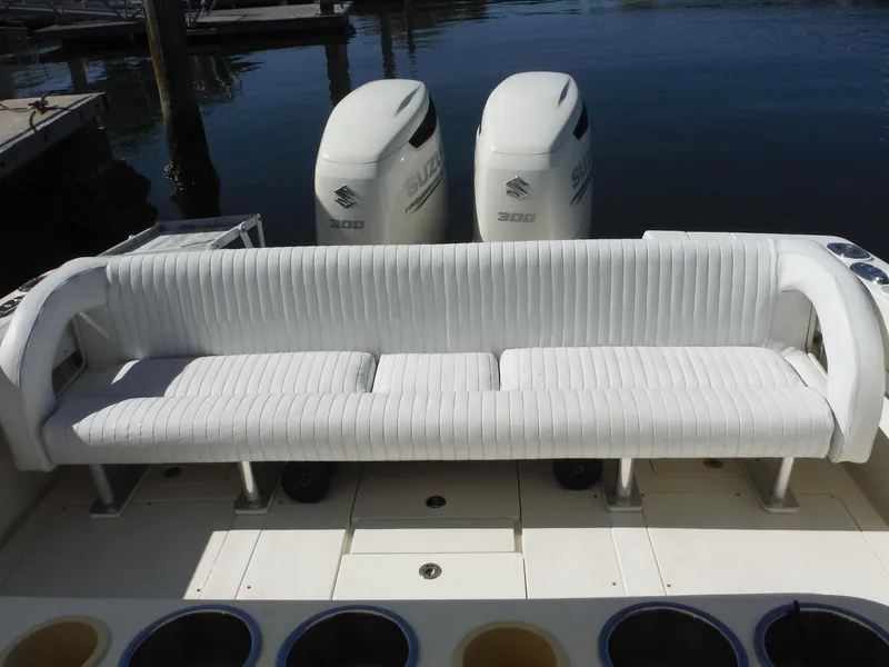 Slide: The Image of 1996 Intrepid 339 Walk Around boat interior with steering console and seating. - 24