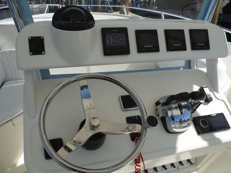 Slide: The Image of 1996 Intrepid 339 Walk Around boat with white seating and dual Suzuki outboard engines. - 25