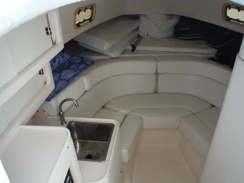 Slide: The Image of 1996 Intrepid 339 Walk Around boat with white cushioned seating and dual Suzuki engines. - 35
