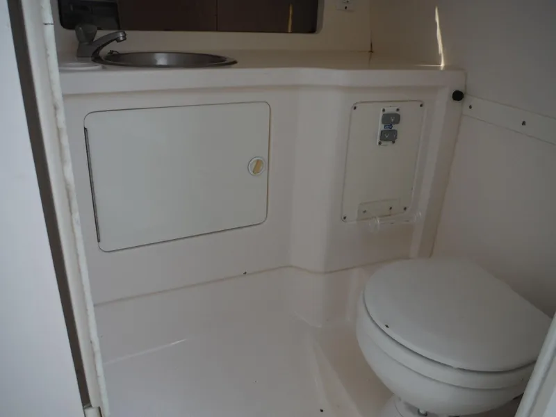Slide: The Image of 1996 Intrepid 339 Walk Around boat bathroom with sink and toilet. - 39