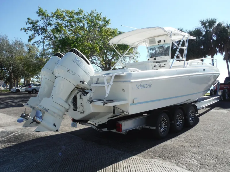 Slide: The Image of 1996 Intrepid 339 Walk Around boat on trailer, parked outdoors. - 4