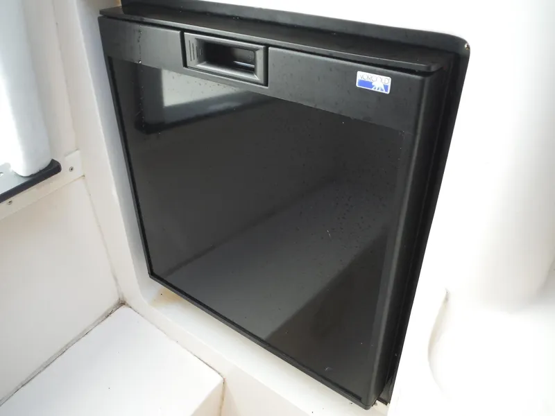 Slide: The Image of 1996 Intrepid 339 Walk Around boat interior bathroom with toilet and compact design. - 41