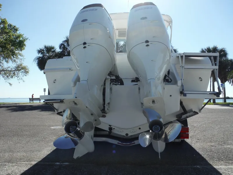 Slide: The Image of 1996 Intrepid 339 Walk Around boat on trailer with dual outboard motors. - 5