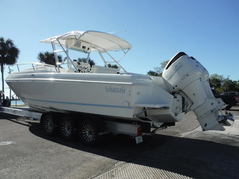 Slide: The Image of 1996 Intrepid 339 Walk Around boat with dual outboard engines, rear view. - 6