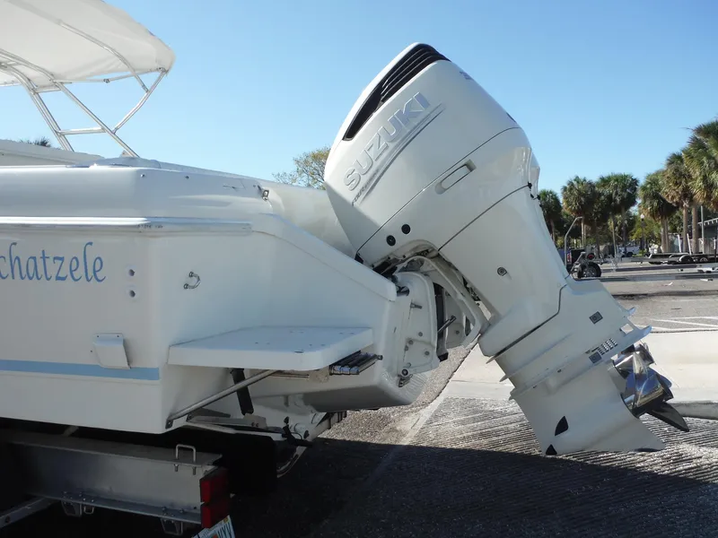 Slide: The Image of 1996 Intrepid 339 Walk Around boat on trailer, marina background. - 9