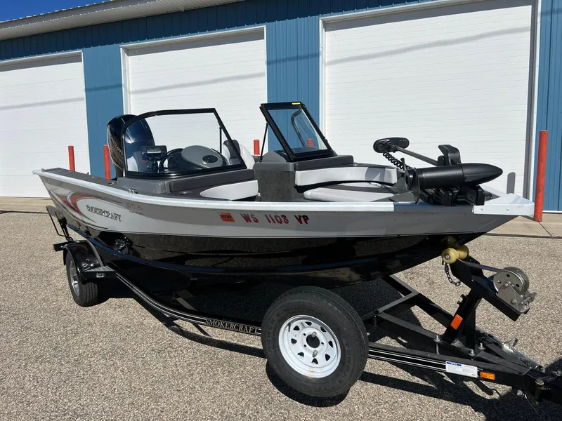 Slide: The Image of 2017 Smoker Craft 172 Ultima Fish n Ski boat on trailer, parked outdoors. - 0