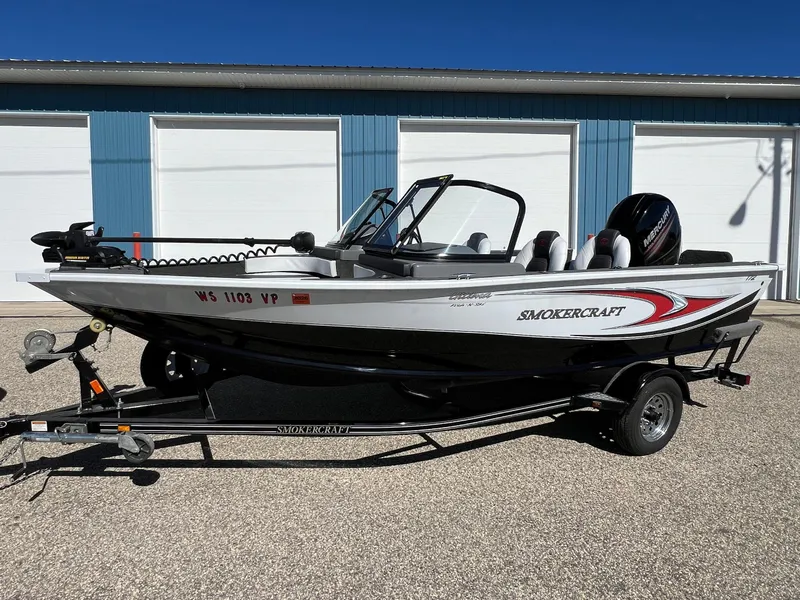Slide: The Image of 2017 Smoker Craft 172 Ultima Fish n Ski boat on trailer, parked outdoors. - 15