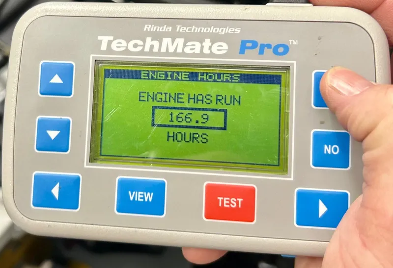 Slide: The Image of Hand holding TechMate Pro displaying 166.9 engine hours for 2017 Smoker Craft 172 Ultima. - 2