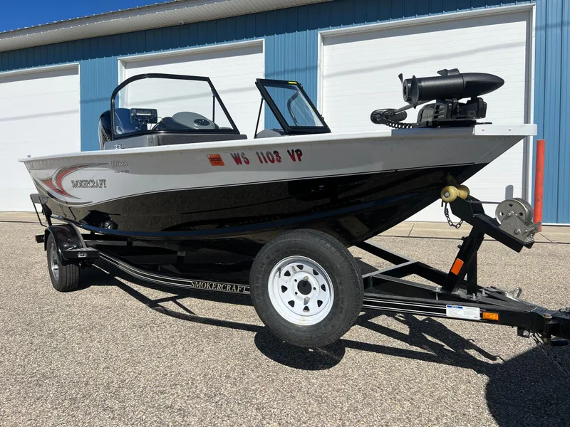 Slide: The Image of 2017 Smoker Craft 172 Ultima Fish n Ski boat on trailer, parked outdoors. - 4
