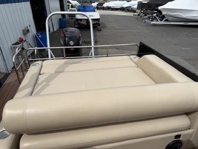 Slide: The Image of 2021 Bentley Pontoons 253 with beige seating, docked near other boats. - 10